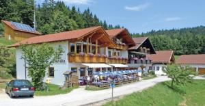 a building with a lot of tables in front of it at Berggasthof-Pension Seminar- und Tagungshaus Menauer in Grandsberg +12 photos