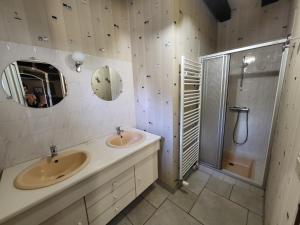 a bathroom with two sinks and a shower at Le Logis d'Aliénor - Baie du Mont St-Michel in Baguer-Pican +16 photos