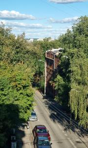 a row of cars parked on a street with trees at Old Town Apartment Bydgoszcz in Bydgoszcz +2 photos
