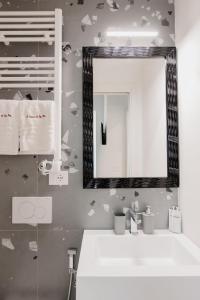 a bathroom with a white sink and a mirror at A Casa Di Lu Na 3 in Bologna +36 photos