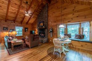 a living room with a fireplace in a log cabin at Yearling in Banner Elk