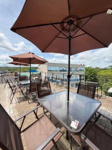 a table and chairs with an umbrella on a patio at View Theras Hotel in Doradal +49 photos
