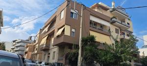 a building on a street with cars parked in front of it at Asimelia Luxury Apartment in Heraklio