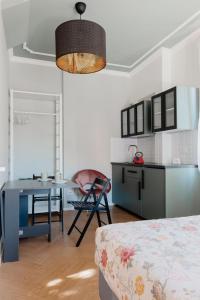 a living room with a table and a kitchen at A Casa Di Lu Na 3 in Bologna