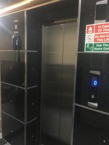 an elevator in a building with a sign on it at Raj Mahal Inn in New Delhi