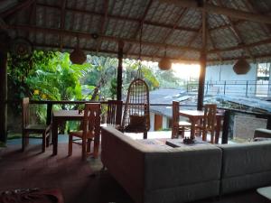a living room with a couch and a table and chairs at Freedom Camp, Ella in Ella