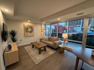 a living room with a couch and a table at Modern and Chic One Bedroom Apartment in Downtown in Halifax