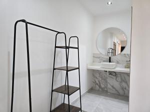 a bathroom with a shelf and a mirror at View Theras Hotel in Doradal +40 photos