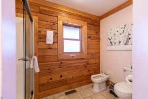 a bathroom with a toilet and a window at The Heartwood in Linville +30 photos