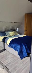 a large bed with blue sheets in a bedroom at Canal Stay in Cloondara