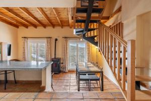 een woonkamer met een trap en een tafel en stoelen bij Duplex deluxe 23 B in Sierra Nevada