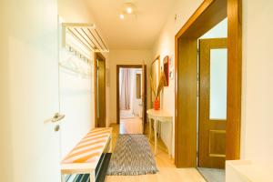 a hallway with a door and a bench and a table at grünraum Apartment in Kleinsöding