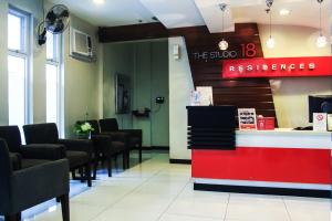 a salon with a waiting room with chairs and a counter at The Studio 18 Residences in Manila