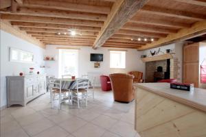 a kitchen and living room with a table and chairs at Lauseig in Lourdios-Ichère