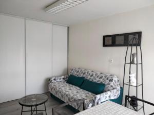 a living room with a couch and a table at La Goélette in Bazincourt-sur-Saulx