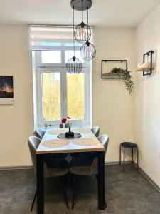 a dining room with a table and a window at Apartmán v centru Trutnova in Trutnov
