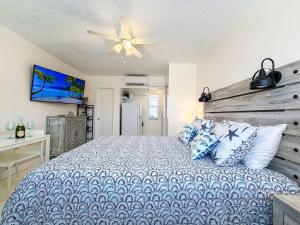 a bedroom with a bed and a ceiling fan at Exclusive Studio Steps To The Beach With Pool in Hollywood Beach +23 photos