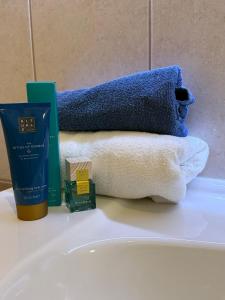 un lavabo con toallas y una botella de jabón. en B4 Garden ***, en Siófok
