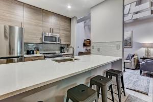 a kitchen with a counter and two stools at Parker's Collection Unit 5 in Savannah +22 photos