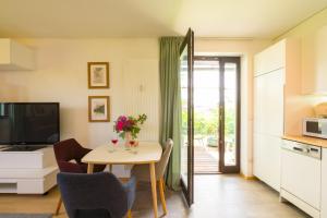 a kitchen and dining room with a table and chairs at grünraum Apartment in Kleinsöding