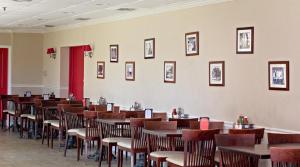 a row of tables and chairs in a restaurant at Iberia House & Suites in New Iberia
