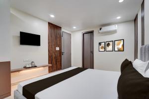 a bedroom with a large bed and a television at Townhouse DSIDC Bawana Formerly Kanhaiya Residency in Bawāna