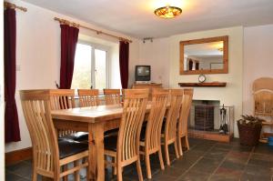 a dining room with a wooden table and chairs at Netherend in Threlkeld