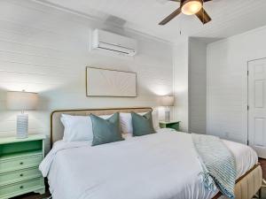 a bedroom with a bed and a ceiling fan at Beachside Villa Unit 5 in Tybee Island +21 photos