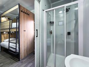a bathroom with a shower and a sink at Beds Inn Midrand in Midrand +28 photos