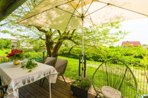 a table and chairs with an umbrella on a deck at grünraum Apartment in Kleinsöding