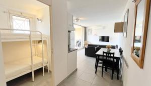 a small apartment with a kitchen and a living room at Appartement 6 personnes - vue mer Baie de Cannes - Théoule sur mer - BESNARD in Théoule-sur-Mer +9 photos