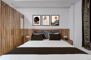 a bedroom with a bed with four pictures on the wall at Hotel O OM SAI HOTEL in Kākori +5 photos