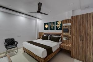 a bedroom with a bed and a chair in it at Hotel O OM SAI HOTEL in Kākori