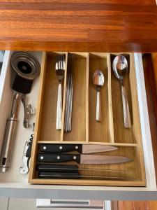 a drawer in a kitchen with utensils in it at Les gîtes Lanmou 1 in La Désirade