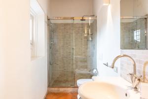 a bathroom with two sinks and a shower at Luxe Paradise - 4 person, Historic Center in Modena