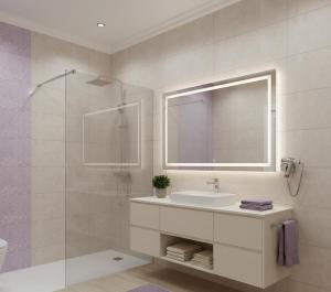 a bathroom with a sink and a mirror and a shower at La-Sa Apart Hotel in Icmeler +9 photos