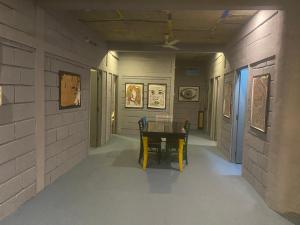 a hallway with a table and chairs in a museum at Irishhome stay in Hosūr