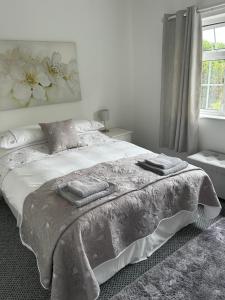 a bedroom with a bed with a blanket and a window at Haralyn in Bunclody