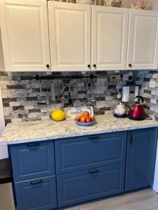 a blue kitchen counter with a bowl of fruit on it at Haralyn in Bunclody +14 photos