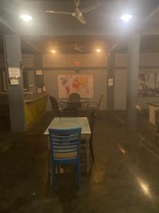 a room with a table and a blue chair at Irishhome stay in Hosūr