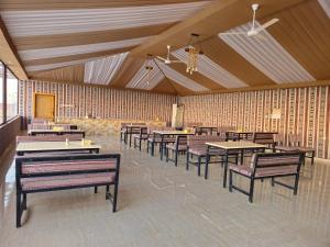 a restaurant with benches and tables in a room at SILENT SKY lUXURY CAMP in Wadi Rum +94 photos