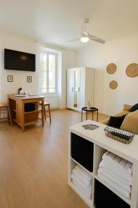 a living room with a couch and a table at Côté Vieil Antibes in Antibes