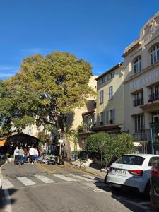 a group of people walking down a street next to a building at Côté Vieil Antibes in Antibes