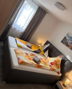 a room with a couch with pillows and a window at Wohnung VS in Villingen-Schwenningen