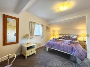 a bedroom with a bed and a mirror and a window at Broadoak Barn in Ellesmere +10 photos