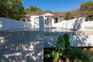 una casa con una recinzione bianca e una pianta di Villa Anni a Città di Skiathos