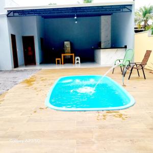 a pool with a fountain in the middle of a patio at Casa Pomar in Bonito +12 photos
