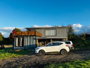 a white car parked in front of a house at Casa con vista a los volcanes y Lago Llanquihue in Puerto Varas
