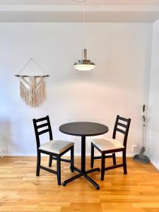 a table and two chairs in a room at Central Suite with Balcony in Helsinki