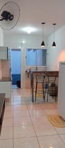 a kitchen with a table and chairs in a room at Casa de férias Pôr do Sol 2 in Presidente Epitácio